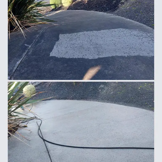 Concrete driveway with a cleaned test strip next to the untouched surface
