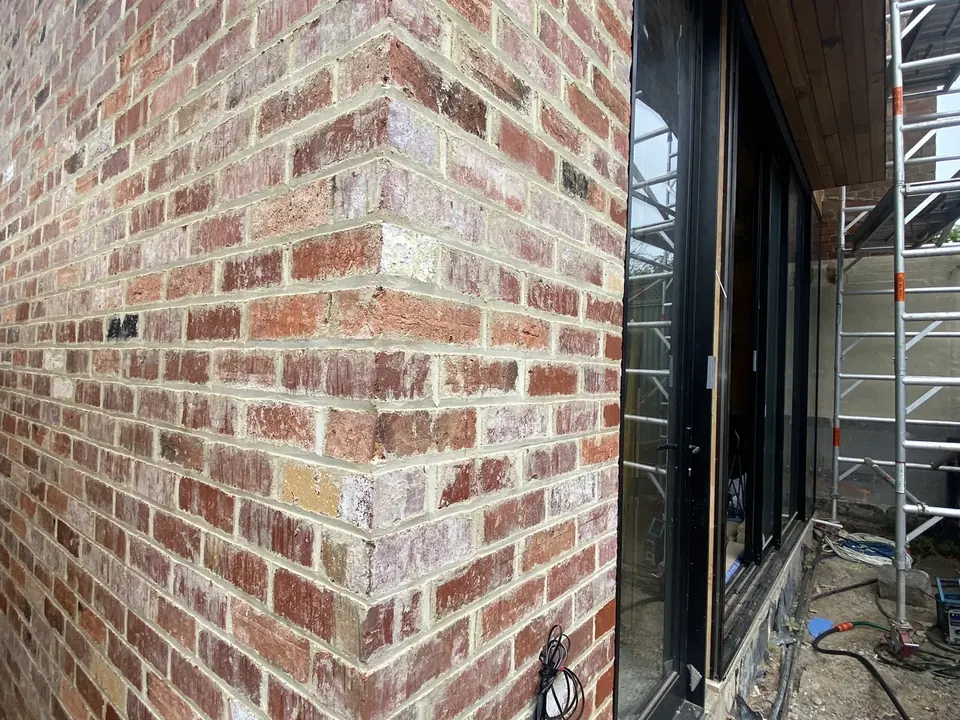 After: the same new-build elevation cleaned